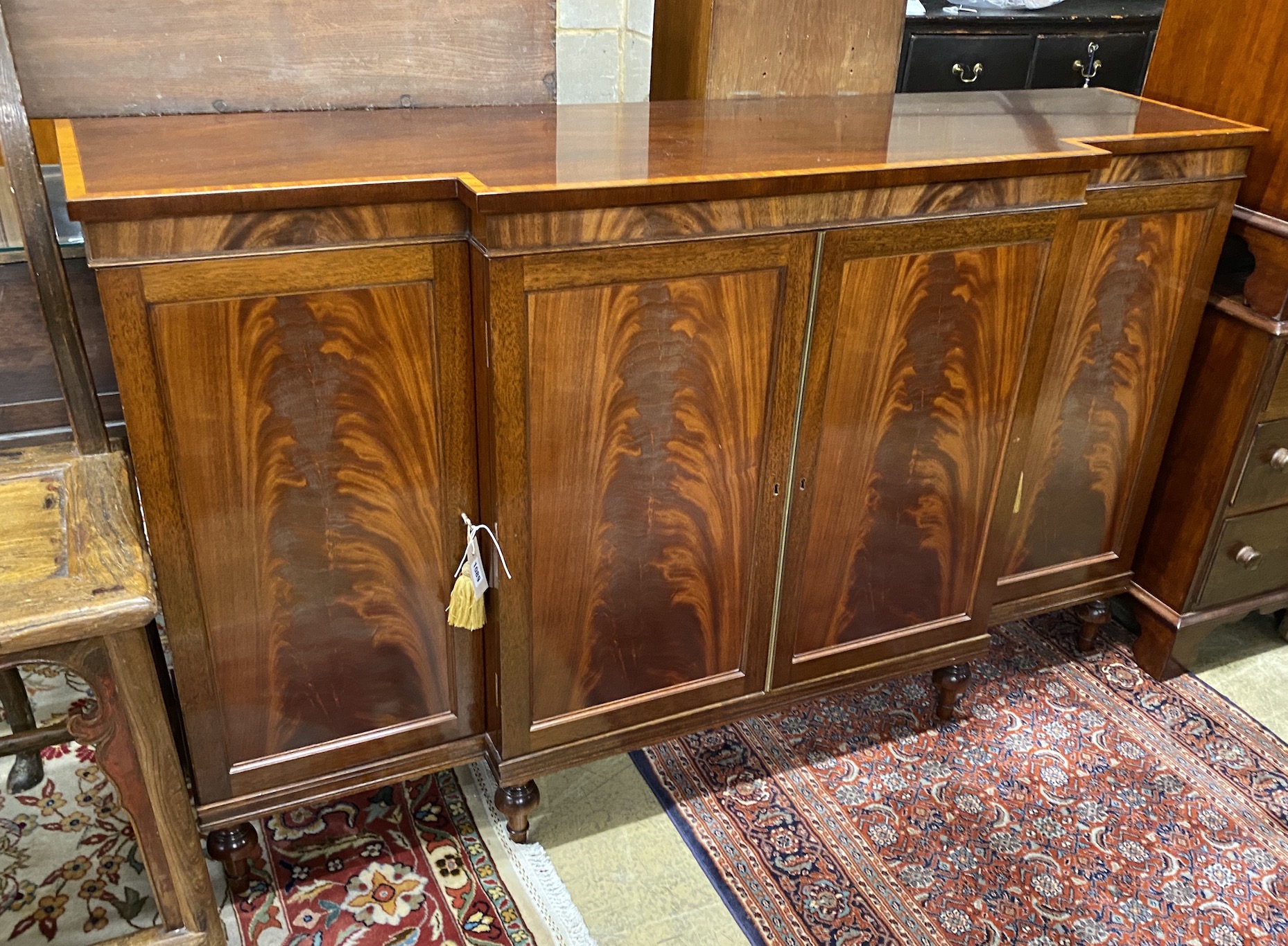 A reproduction satinwood banded mahogany breakfront side cabinet, width 152cm, depth 40cm, height 92cm